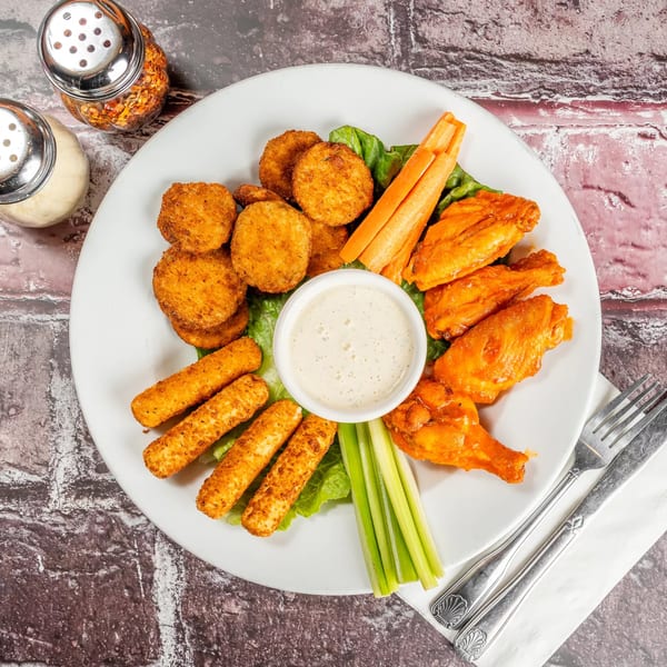Marri's Pizza & Pasta appetizer platter with fried zucchini, mozzarella sticks, buffalo wings, and dip.