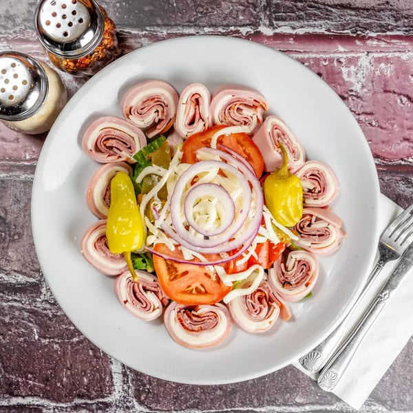 Marri's Pizza & Pasta antipasto salad with rolled meats, cheese, tomatoes, onions, and peppers.